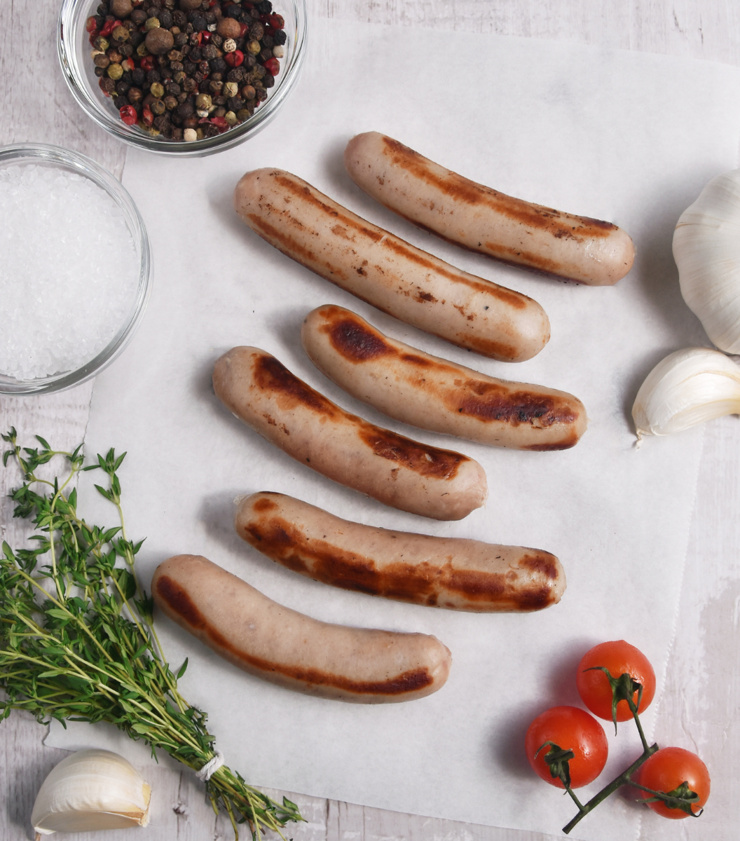 Grilled Wicks Manor English Pork Sausage Chipolatas with garlic, red grade tomato and spice by side