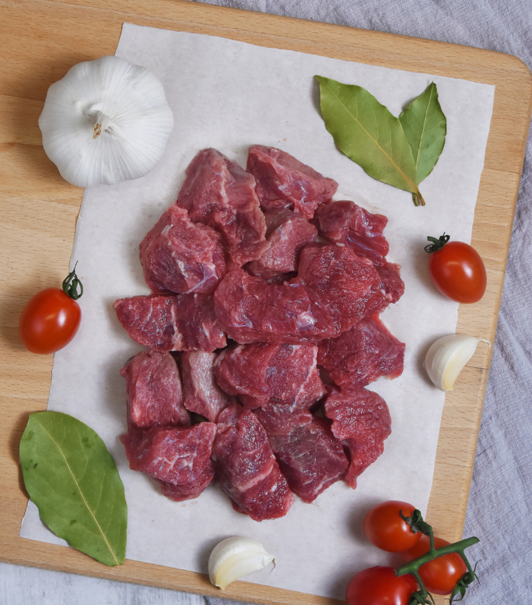 A large portion of fresh New Zealand Angus diced beef with garlic, red grape tomato and bay leaves by the side